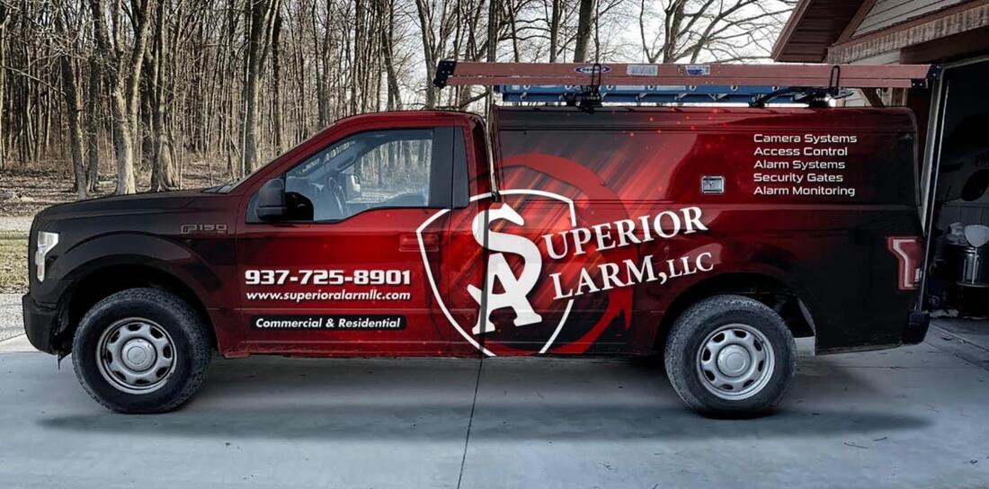 Superior Alarm Truck with logo and services offered.